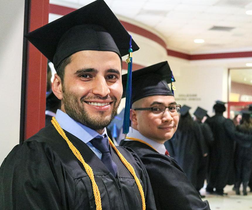 An M State student smiles at graduation